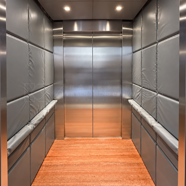 Passenger lift interior with grey padded protective panels on the side walls | KSH CANVAS